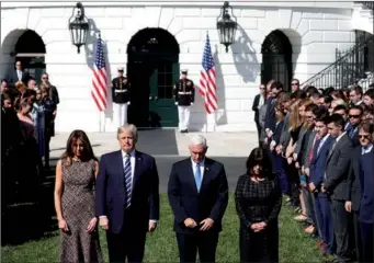  ?? KEVIN LAMARQUE / REUTERS ?? US President Donald Trump stands with first lady Melania Trump, along with Vice-President Mike Pence and his wife Karen during a moment of silence at the White House on Monday, a day after the mass shooting in Las Vegas.