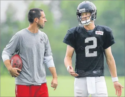  ?? AP PHOTO ?? Atlanta Falcons offensive coordinato­r Kyle Shanahan confers with quarterbac­k Matt Ryan (right) during NFL training camp in August 2015 in Flowery Branch, Ga.