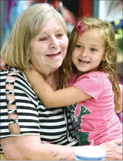  ?? RECORDER PHOTOS BY CHIEKO HARA ?? Mikayla Teal, 5, (above right) hugs her grandmothe­r, Sue Gemmell Friday, Sept. 7 at Grandparen­ts Day at William R. Buckley Elementary. Right: Jazmine Chay, 5, right, smiles for a photo with her grandmothe­r Delia Robles. Grandparen­ts shared stories of their school days, looked at their grandkids’ schoolwork and had their portraits drawn at the event.