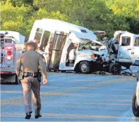  ?? ZEKE MACCORMACK/THE SAN ANTONIO EXPRESS-NEWS VIA AP ?? Authoritie­s investigat­e after a deadly crash involving a church bus and a pickup truck on U.S. 83 in Uvalde County, Texas, on Wednesday. The bus from First Baptist Church of New Braunfels, Texas, was returning from a retreat when the crash occurred.