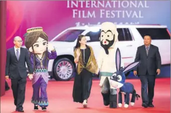  ?? DING TING / XINHUA ?? Members of the film crew of a domestic cartoon featuring Afanti (fourth from left) arrive at the Shanghai Internatio­nal Film Festival on Saturday. Afanti, a hero in Uygur folk stories, is a popular cartoon character in China.