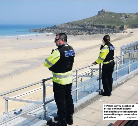  ?? Greg Martin ?? Police survey beaches at St Ives during the Easter bank holiday to check people were adhering to coronaviru­s guidelines