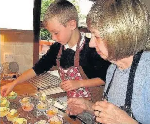  ??  ?? Happy together Liam cooks with his grandmothe­r