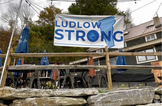  ?? LISA RATHKE/ASSOCIATED PRESS ?? A “Ludlow Strong” sign outside a restaurant in Ludlow, Vt., earlier this month. The town, home to the Okemo ski resort, has done significan­t rebuilding since severe flooding during the summer. Most businesses say they are ready for ski season.