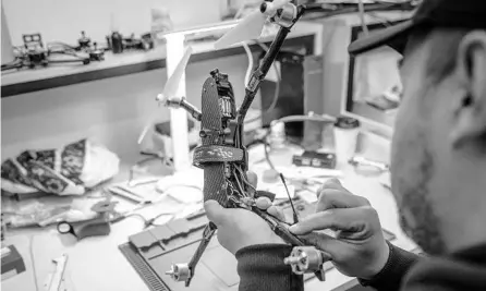  ?? FINBARR O’REILLY/THE NEW YORK TIMES ?? A technician modifies a racing drone at a workshop supporting the Ukrainian military on April 19 in western Ukraine.