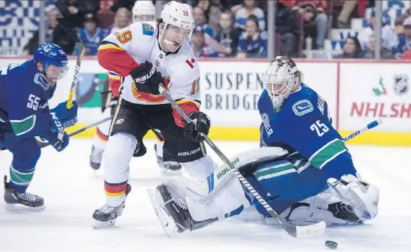  ?? THE CANADIAN PRESS ?? Matthew Tkachuk beats Canucks goalie Jacob Markstrom in Calgary’s recent 6-1 win over Vancouver. Markstrom admits the constant losing “absolutely sucks.”