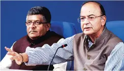  ??  ?? Finance Minister Arun Jaitley ( right) with Law Minister Ravi Shankar Prasad at a press meet in New Delhi on Wednesday