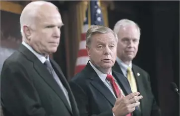  ?? Justin Sullivan Getty Images ?? SEN. LINDSEY GRAHAM, center, says that President Trump will have “holy hell to pay” if he fires Atty. Gen. Jeff Sessions and that ousting special counsel Robert S. Mueller III could spell the end of his presidency.