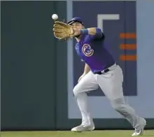  ?? Alex Brandon/Associated Press ?? Cubs left fielder Kyle Schwarber catches a ball hit by the Nationals’ Bryce Harper in the sixth inning.