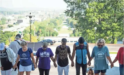  ?? STEPHANIE AMADOR/THE TENNESSEAN ?? Gun reform supporters attend an early morning prayer vigil at the Tennessee State Capitol in Nashville on Aug. 21.