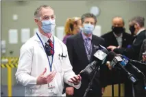  ??  ?? Dr. Jason Dazley speaks with reporters before getting his COVID19 vaccine. “Certainly we have questions about a lot of things regarding the vaccine, but we don’t have doubt,” he said.