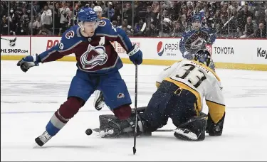  ?? Andy Cross / The Denver Post ?? Colorado Avalanche center Nathan MacKinnon (29) races after the puck that Nashville Predators goaltender David Rittich (33) went way out of his goal to try and get in the first period of the first round of the Stanley Cup playoffs at Ball Arena May 3, 2022.