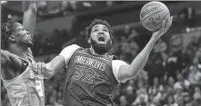  ?? REUTERS ?? Minnesota Timberwolv­es center Karl-Anthony Towns tries a layup during a game against Charlotte Hornets on Monday.