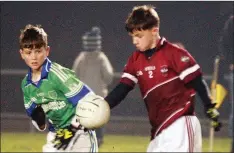  ??  ?? Mikey Kinsella of Castletown watched closely by Colin Carley.