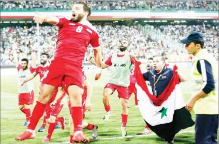  ?? AT TA KENARE/AFP ?? Syria players celebrate at the end of their FIFA World Cup 2018 qualifying draw with Iran at the Azadi Stadium in Tehran on September 5.