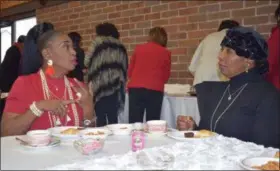  ?? BRIANA CONTRERAS — THE MORNING JOURNAL ?? From left, Michaelle Montgomery of Elyria chats with friend Doris Rogers of Lorain over tea and treats during Direct Action for Central Lorain’s Afternoon Tea on Feb. 10 at First Baptist Church, 1510 Cooper Foster Park Road in Lorain. Montgomery and...