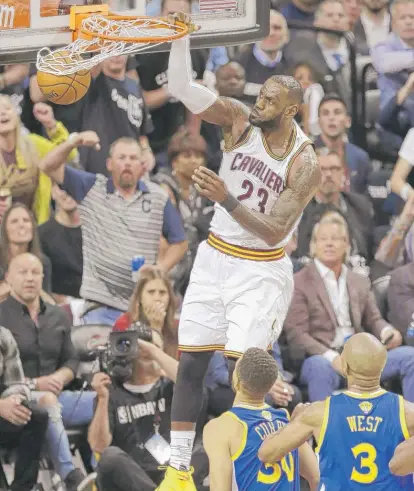  ?? | TONY DEJAK/ AP ?? Cavaliers forward LeBron James ( 31 points, 10 rebounds, 11 assists) throws down a dunk in the first half of Game 4.
