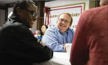  ??  ?? Darrell Pursiful, of First Baptist Church of Christ on High Place, talks to Alveno Ross, a deacon at First Baptist Church on New Street, at the Thanksgivi­ng potluck at First Baptist Church on Nov. 19.