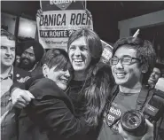  ?? JAHI CHIKWENDIU/THE WASHINGTON POST VIA AP ?? Danica Roem, center, who ran for house of delegates against GOP incumbent Robert Marshall, is greeted by supporters as she prepares to give her victory speech in Manassas, Va.