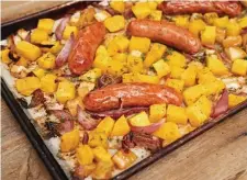  ??  ?? APPLE OF YOUR EYE: An apple and butternut sheet pan dinner with chicken sausage gets added flavor from both apple cider and apple cider vinegar.