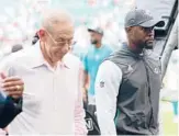  ?? JOHN MCCALL/SUN SENTINEL ?? Former Dolphins head coach Brian Flores walks off the field next to team owner Stephen Ross, left, after a loss on Oct. 24 in Miami Gardens, Florida.