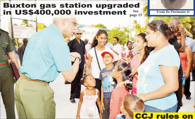  ??  ?? President David Granger (left) sharing a light moment with this family, who were present at the Buxton/ Friendship Gas Station and Plaza’s opening yesterday afternoon.(Ministry of the Presidency photo)