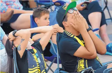  ?? JIM THOMPSON/JOURNAL ?? Amanda Vigil, left, and Lucas Casaus cover their faces in disbelief at a watch party in Civic Plaza during New Mexico United’s 6-1 loss to the Minnesota United on Wednesday.