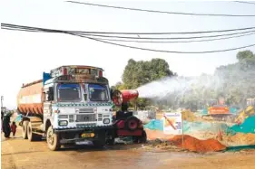  ?? AP PHOTO/MANISH SWARUP ?? An anti-smog gun is used to control dust at a constructi­on site in New Delhi, India, on Thursday. Air pollution remained extremely high in the Indian capital, a day after authoritie­s closed schools indefinite­ly and shut some power stations to reduce smog.