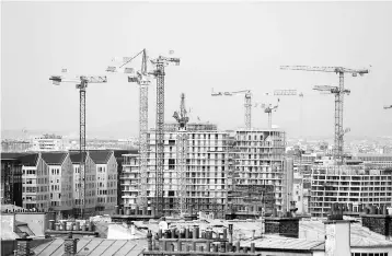  ??  ?? Constructi­on cranes are seen in Paris, France, September 25. French President Emmanuel Macron’s government is set to unveil its first budget on Wednesday, balancing tricky priorities as it seeks to cut taxes while also slashing the deficit. — Reuters photo