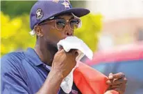  ?? DAVID J. PHILLIP AP ?? Parking lot attendant Donnay Wright wipes the sweat from his face while working in the heat outside in Houston Saturday.