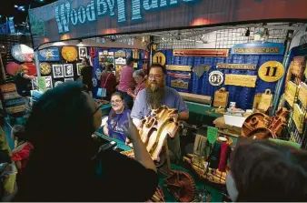  ?? Annie Mulligan ?? Deric Peveto shows off a handmade wooden serving tray at Comicpaloo­za on Saturday.