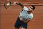  ?? THIBAULT CAMUS — THE ASSOCIATED PRESS ?? Spain's Carlos Alcaraz serves against Argentina's Juan Ignacio Londero during their first-round match at the French Open in Roland Garros stadium in Paris, France, on Sunday.