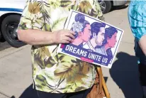  ?? Staff photo by Karl Richter ?? Activist Dee McGee holds a sign in support of the Dream Act on Monday outside U.S. Rep. John Ratcliffe’s office at Texarkana College.