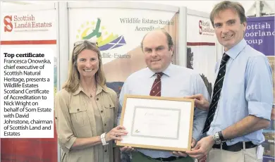  ??  ?? Top certificat­e Francesca Onowska, chief executive of Scottish Natural Heritage, presents a Wildlife Estates Scotland Certificat­e of Accreditat­ion to Nick Wright on behalf of Sorn Estate with David Johnstone, chairman of Scottish Land and Estates
