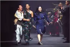  ?? ANNE-CHRISTINE POUJOULAT/AFP ?? Kenzo’s designers Humberto Leon and Carol Lim, and singer Solange Knowles (second left) walk on the runway.