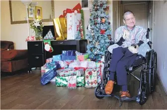  ?? BILL WECHTER ?? Timothy Howard, who has cerebral palsy, has been delighted at the presents piling up under the tree. His caregivers asked for help on Facebook to make his Christmas special.