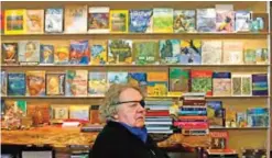  ??  ?? Books about artist Vincent van Gogh are displayed on shelves behind glass artist Dale Chihuly during an interview in his private studio in Seattle.