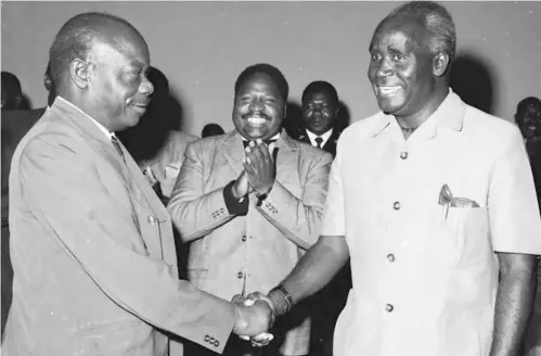  ??  ?? FILEPHOTO: Mr Nkumbula (left) and former President Kaunda shake hands to seal the Choma declaratio­n as Mainza Chona claps.