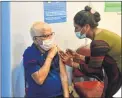  ?? BHUSHAN KOYANDE ?? A beneficiar­y gets the jab on Wednesday