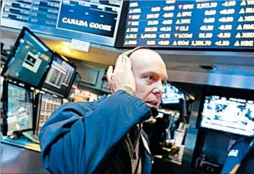  ?? RICHARD DREW/ASSOCIATED PRESS ?? A trader works on the floor Monday, a quiet day at the New York Stock Exchange.