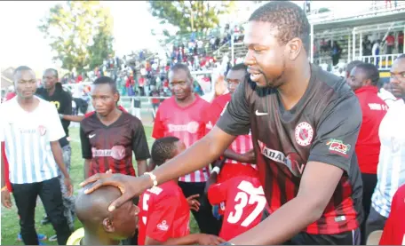  ??  ?? HAPPY FAMILY . . . Yadah Stars owner and technical adviser Prophet Walter Magaya blesses his goalkeeper Tafadzwa Dube amid a wave of celebratio­ns at Morris Depot yesterday following their thumping victory over Triangle. — (Picture by Kudakwashe Hunda)