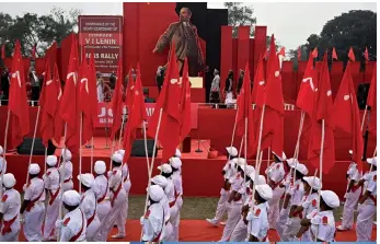  ?? — AFP photo by Dibyangshu Sarkar and Alexander Nemenov ?? Activists and supporters of Socialist Unity Centre of India (Communist) or SUCI(C) a end a mass meeting organised to conclude the death centenary celebratio­n of Vladimir Lenin, in Kolkata.