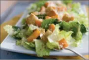  ?? MATTHEW MEAD — ASSOCIATED PRESS FILE ?? A 2012 photo photo shows a Caesar salad with romaine lettuce. Food regulators are urging Americans not to eat any romaine lettuce because of a new food poisoning outbreak.