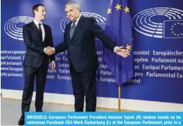  ?? — AFP ?? BRUSSELS: European Parliament President Antonio Tajani (R) shakes hands as he welcomes Facebook CEO Mark Zuckerberg (L) at the European Parliament, prior to a meeting on the data privacy scandal at The European Union headquarte­rs.
