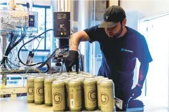  ?? INDIAN COUNTRY TODAY VIA AP ?? A worker from Mobile West Canning cans Luiseno Hazy IPA last summer at the Rincon Reservatio­n Road Brewery, also known as 3R Brewery.