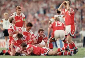  ?? Photograph: Shaun Botterill/Getty Images ?? Kim Vilfort of Denmark is mobbed by teammates after scoring the second goal in their Euro 92 final win over Germany.