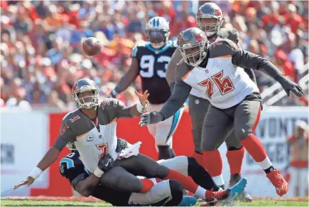  ??  ?? Buccaneers quarterbac­k Jameis Winston fumbles the ball as Panthers defensive end Julius Peppers applies pressures. KIM KLEMENT, USA TODAY SPORTS