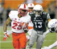  ?? MARCO GARCIA/ASSOCIATED PRESS FILE PHOTO ?? Lobos running back Tyrone Owens, left, running past Hawaii defenders in October in Honolulu, is expected to form a formidable 1-2 punch with Richard McQuarley.