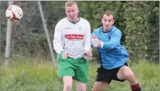  ??  ?? Duleek’s Colin Woods clashes with the Bridge Rovers goalkeeper.