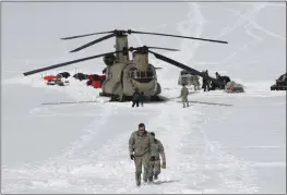  ?? MARK THIESSEN — THE ASSOCIATED PRESS FILE ?? Capt. Corey Wheeler, front, commander of B Company, 1st Battalion, 52nd Aviation Regiment at Fort Wainwright, Alaska, walks away from a Chinook helicopter that landed on the glacier near Denali on the Kahiltna Glacier in Alaska.